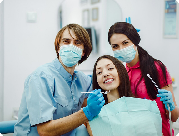 Dental team members smiling with masks on