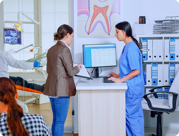 Dental team assisting a patient at the front desk